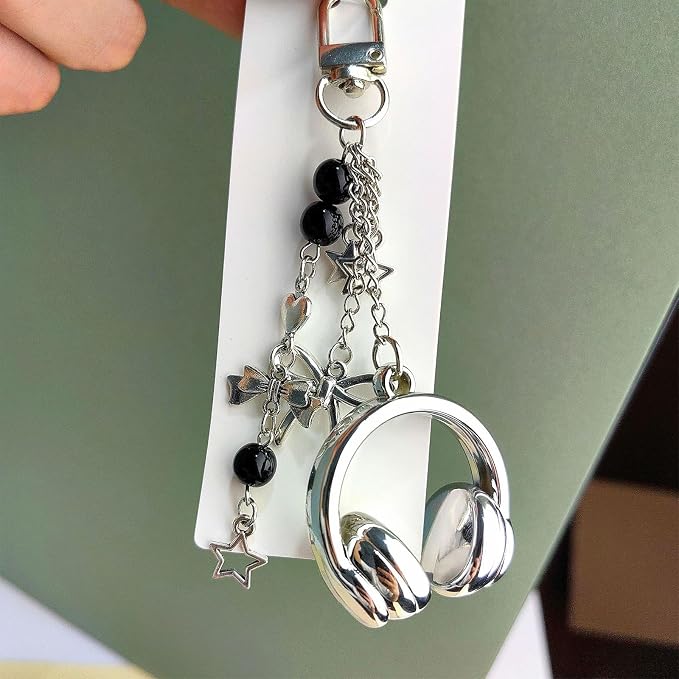 Silver headphone charm keychain close-up with bow and bead details